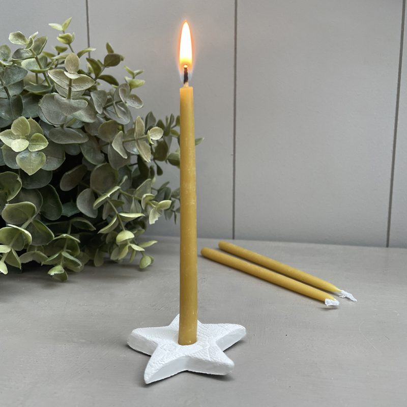 one hour beeswax candle in a star shaped ceramic holder